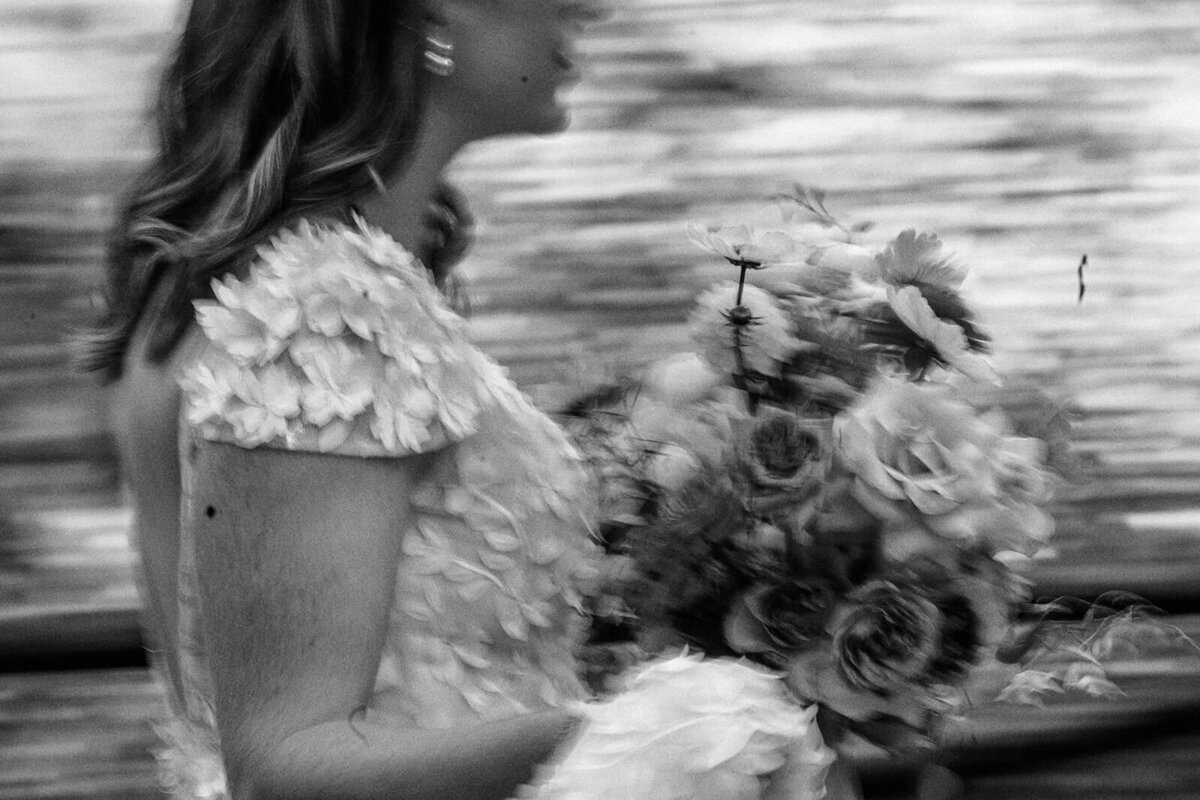 A bride walking with the background blurred showing movement.
