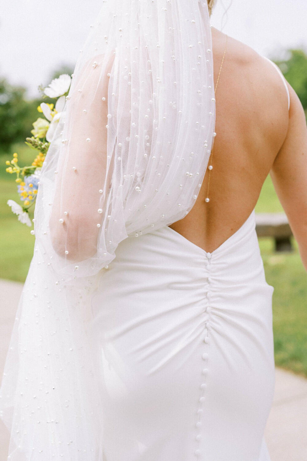 pearls-draping-over-low-back-dress