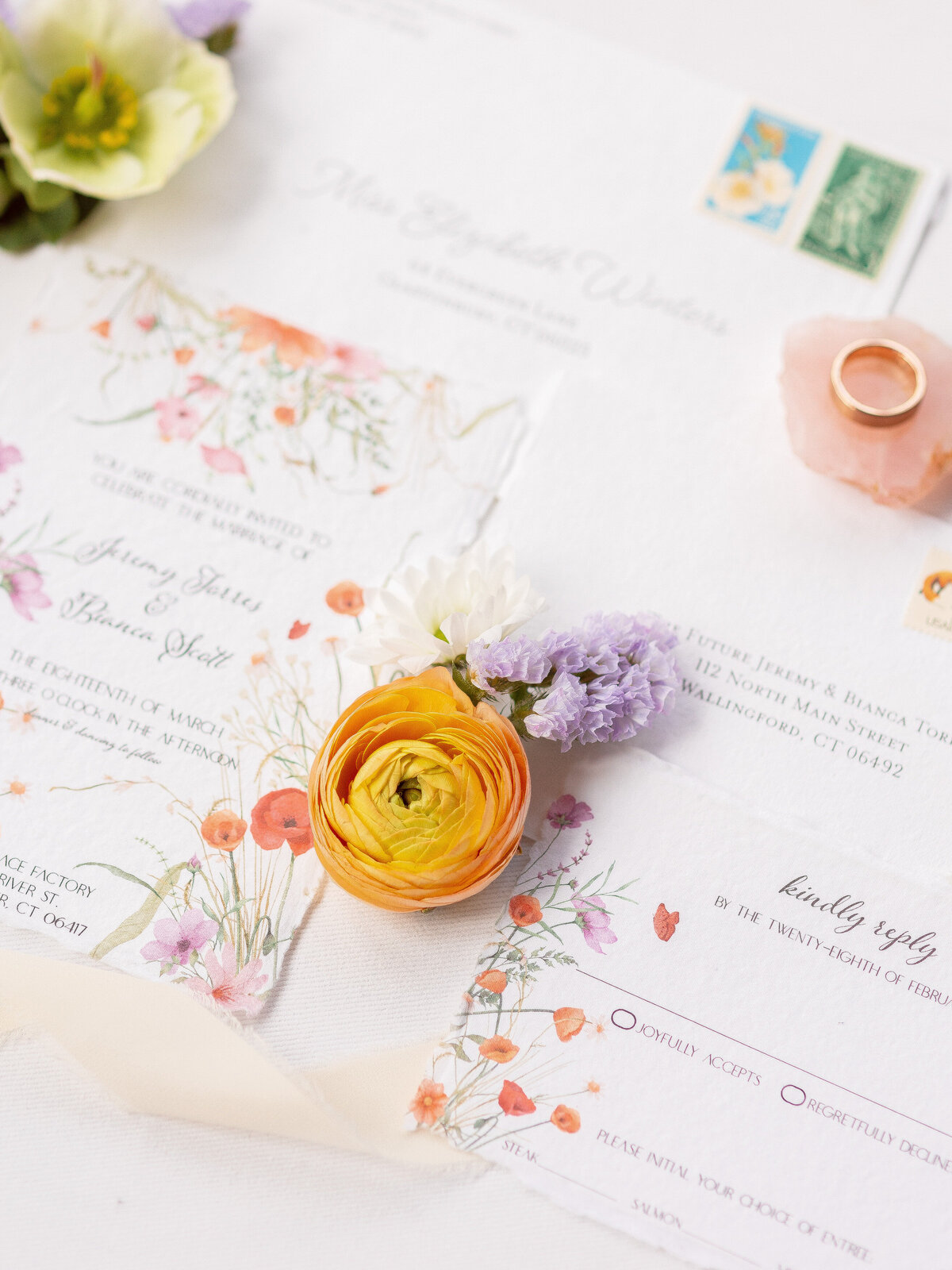 Close up of flowers and wedding invitations