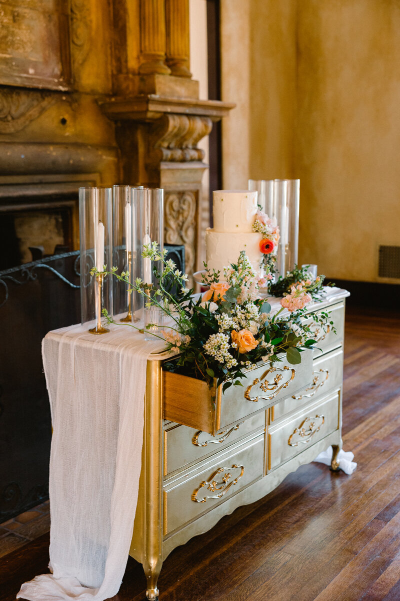 Wedding cake on gold dresser
