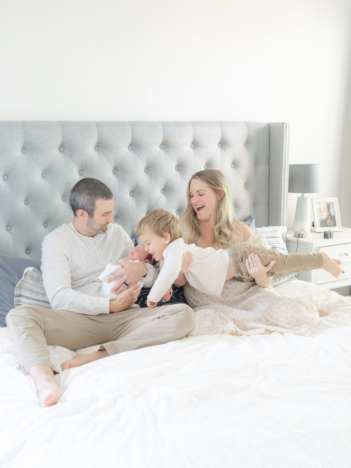family on bed by raleigh family photographer