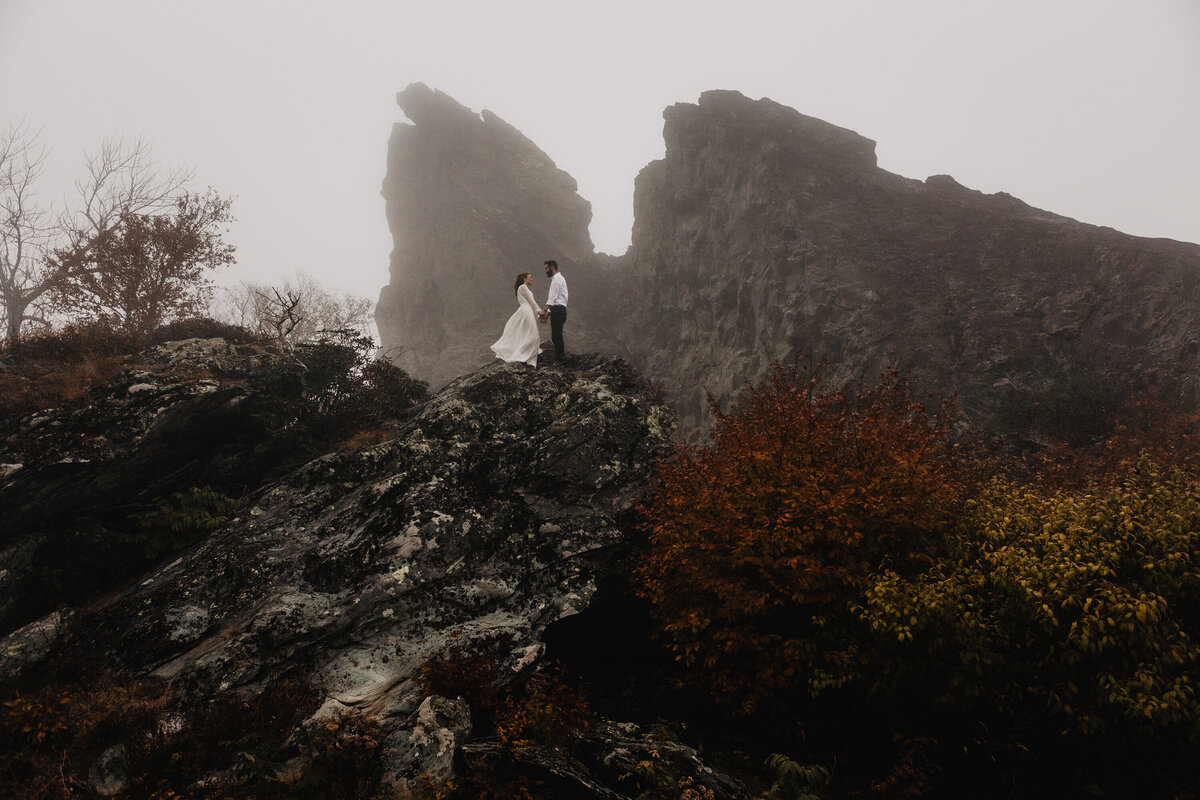 Smoky Mountain elopement with bride and groom rock climbing a mountain