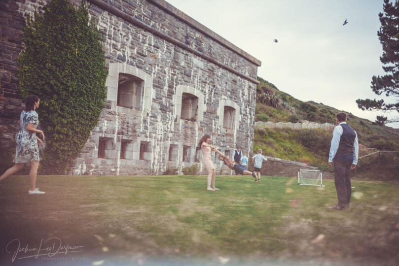 A group of wedding guests playing a game of football