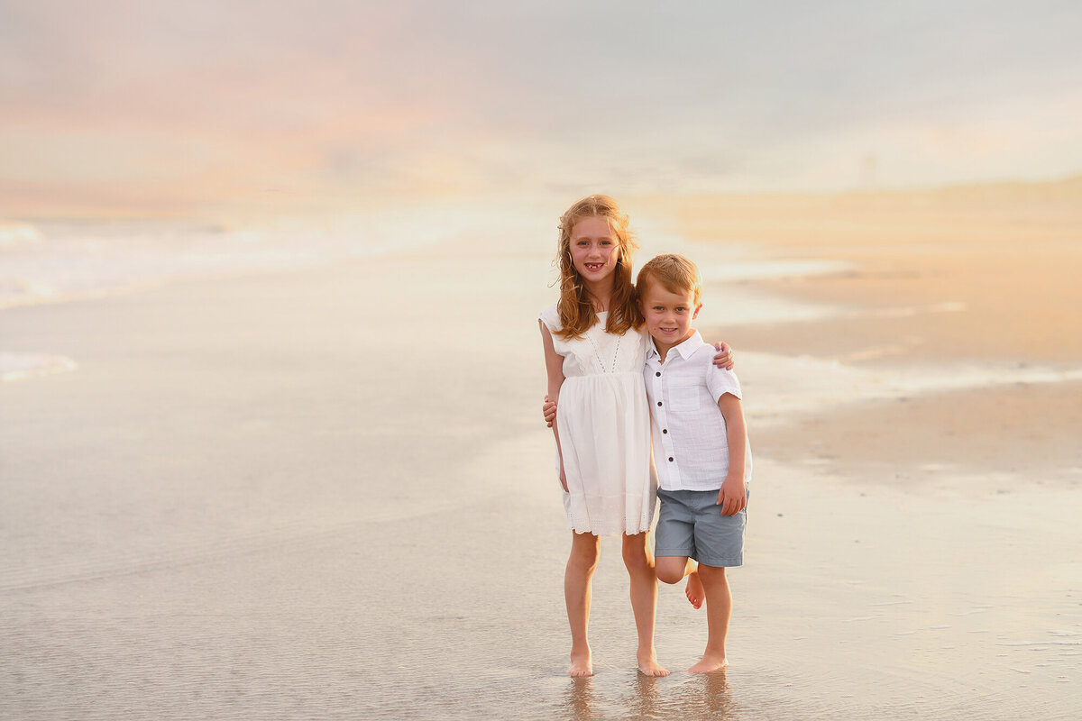 Siblings embrace during Family Pictures on Isle of Palms. 