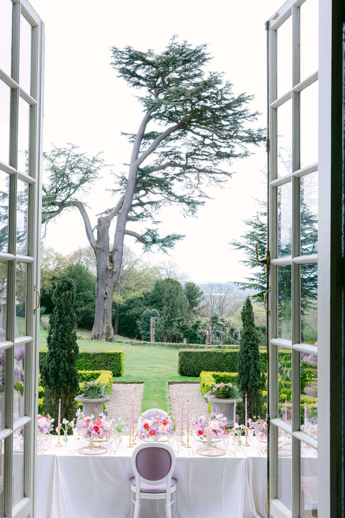 A wedding day photo of the table scape on the reception dinner table at Hedsor House in the UK