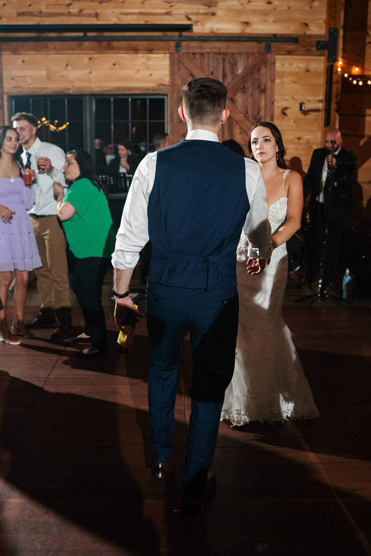 Elegant reception setup with candles, florals, and wooden tables