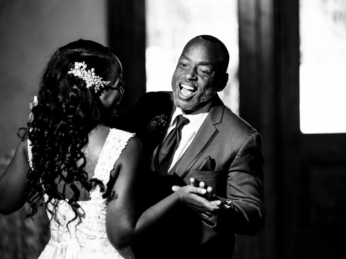 A bride and her father in a candid moment during her wedding.