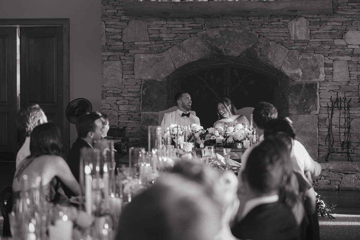 Black and white candid photo of wedding reception toasts at Trillium Links & Golf Club in Cashiers, NC.