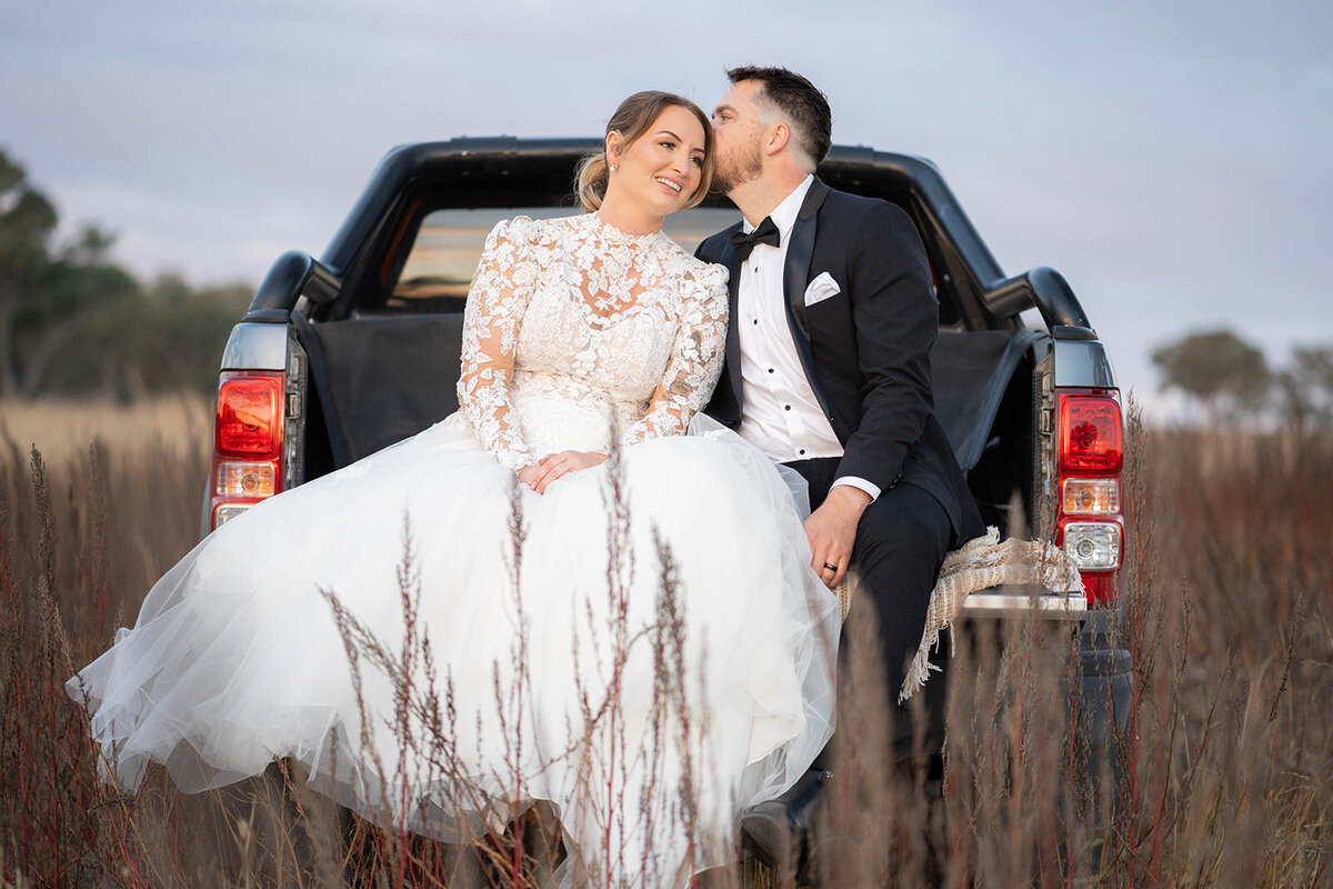 the couple posing with a car