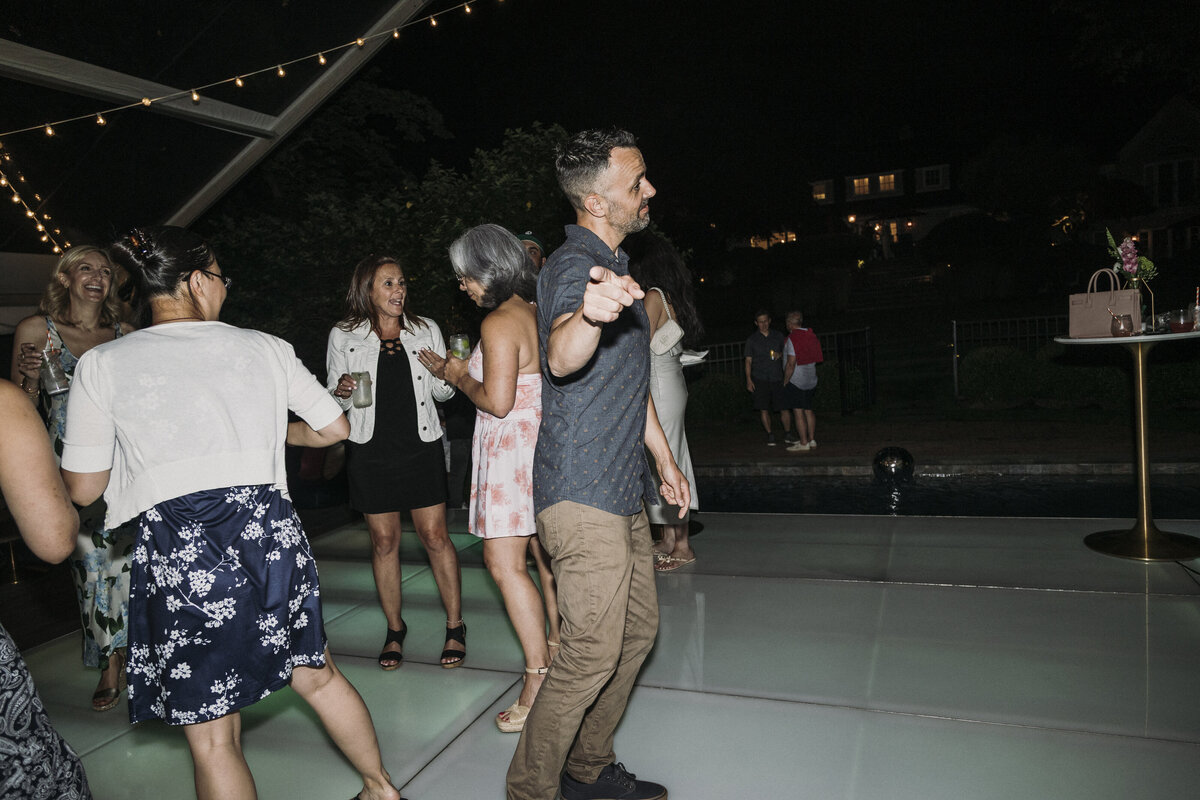 Photo of guests dancing in private backyard party by Mira Park Photography NY based wedding photographer