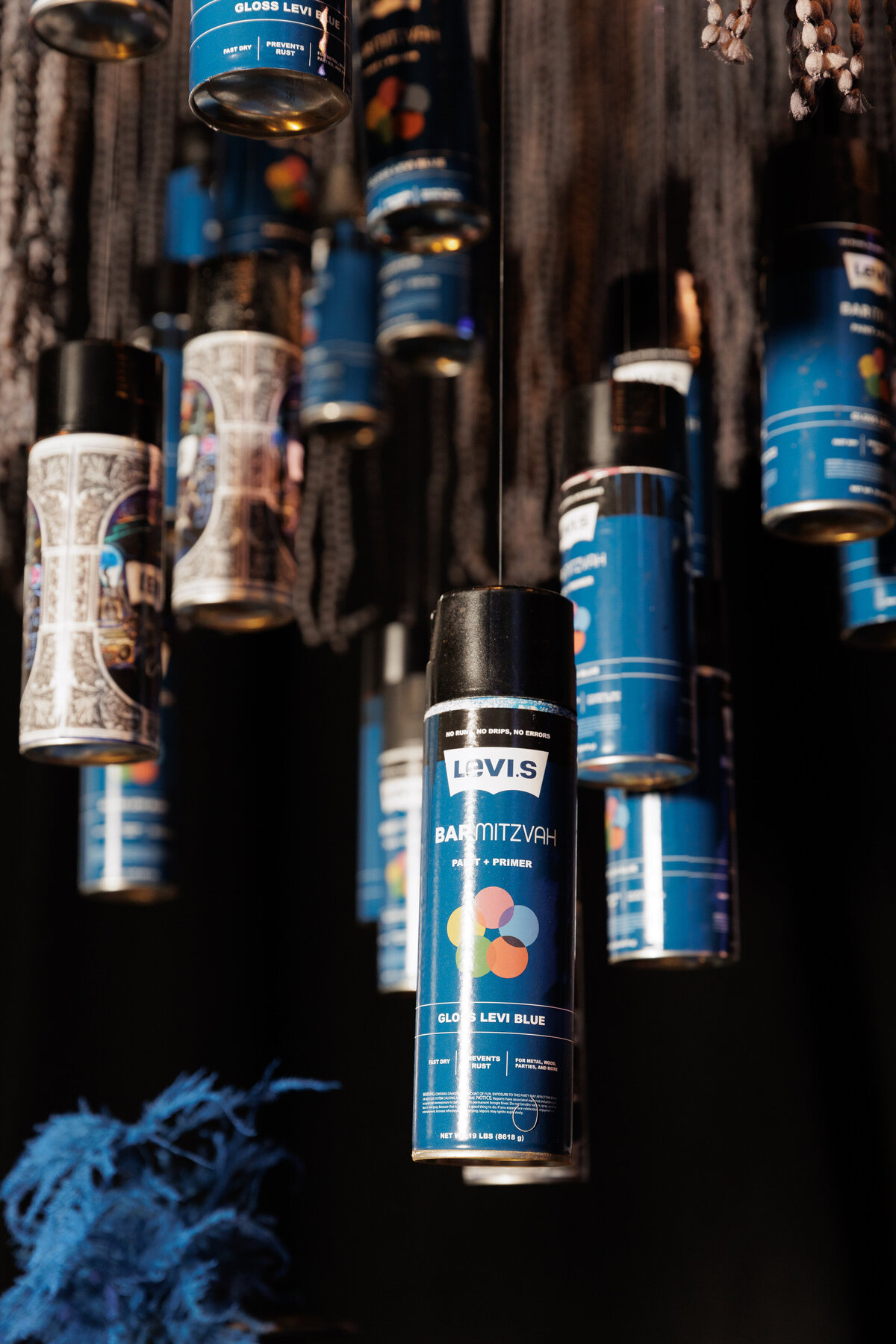 Cans of spray paint hanging from the ceiling