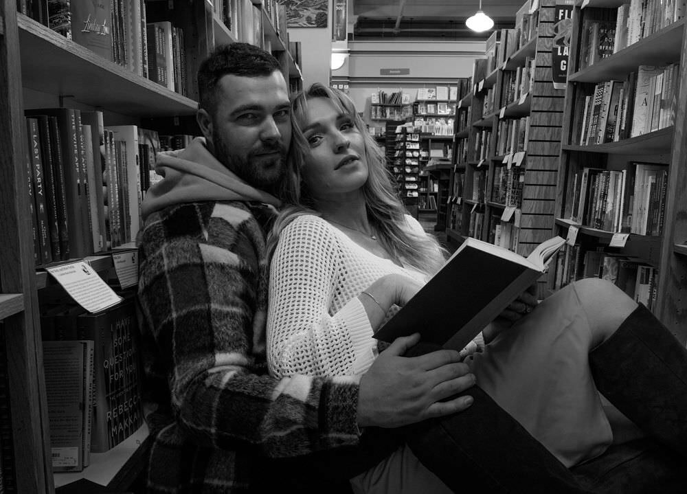 A couple embraces in a moody, cinematic couples session, featuring soft light and deep emotion in Washington.