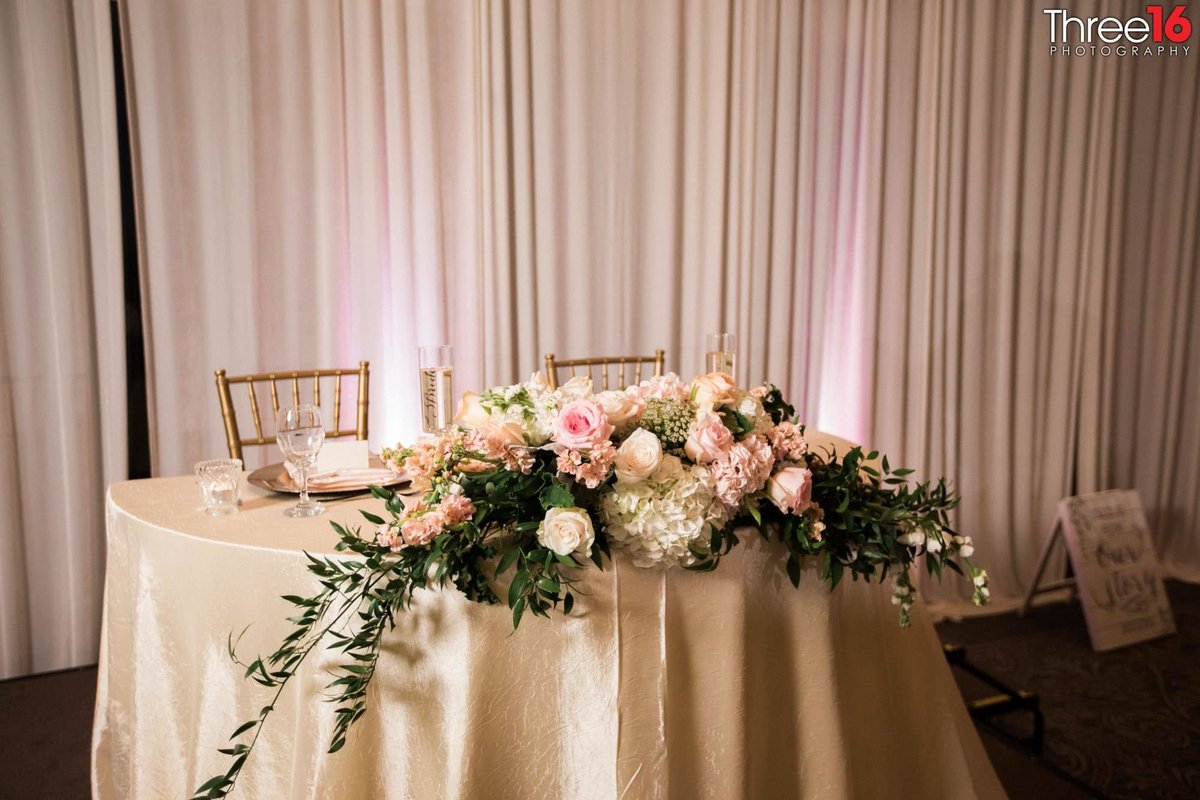 Beautifully decorated Sweetheart Table at wedding reception