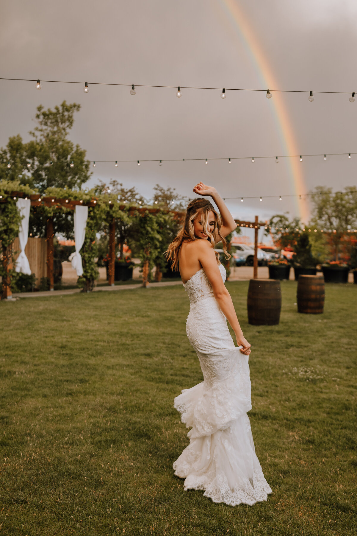 bride dancing under rainbow