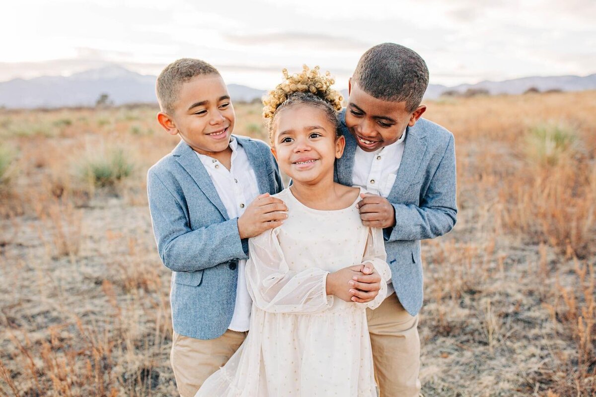 little girl with brothers smiling