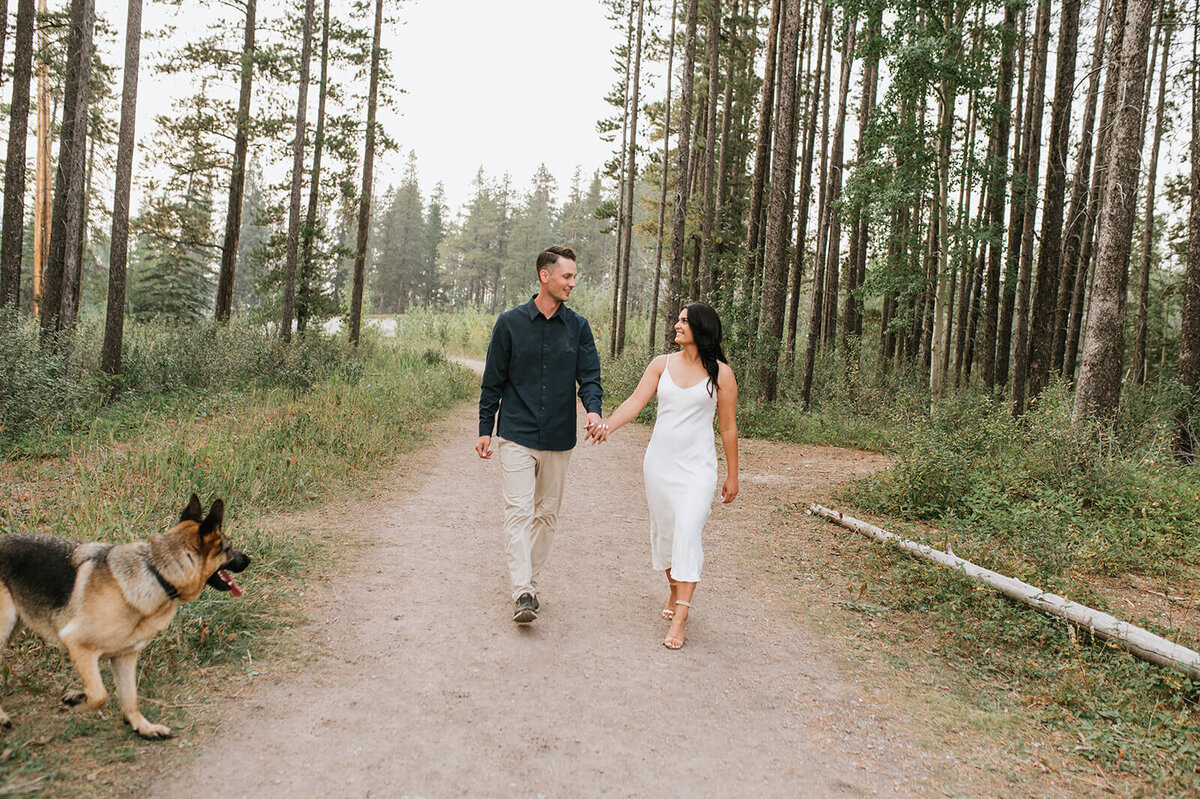 Man-and-woman-walking-with-german-shepard-dog