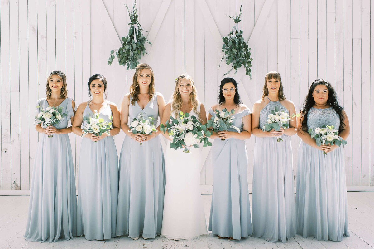 Bridal party with light blue bridesmaids dresses at wedding venue in Quinlan, Texas