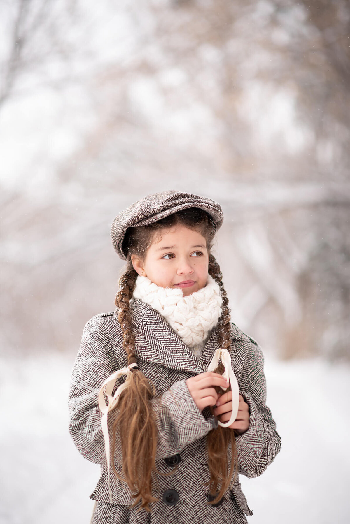 Little girl with pigtail braids and page boy page in the winter. Portrait by Brittany Danielle