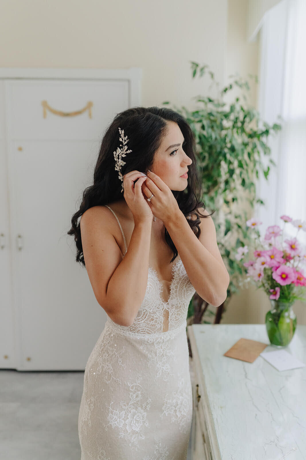 Bride putting earring in