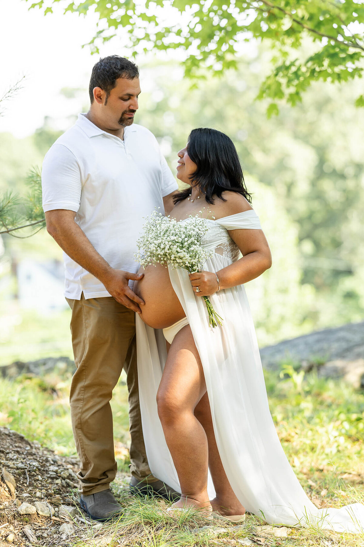 Expecting parents posing looking at each other 