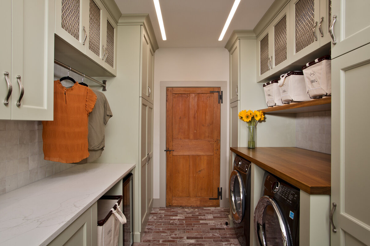 laundry room with light colored cabinets
