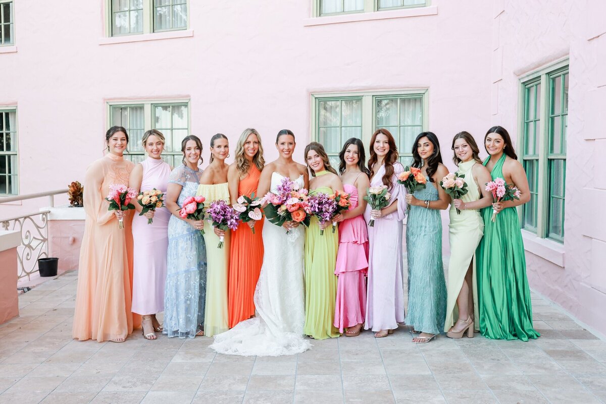 bridesmaids wearing bright dresses in various colors