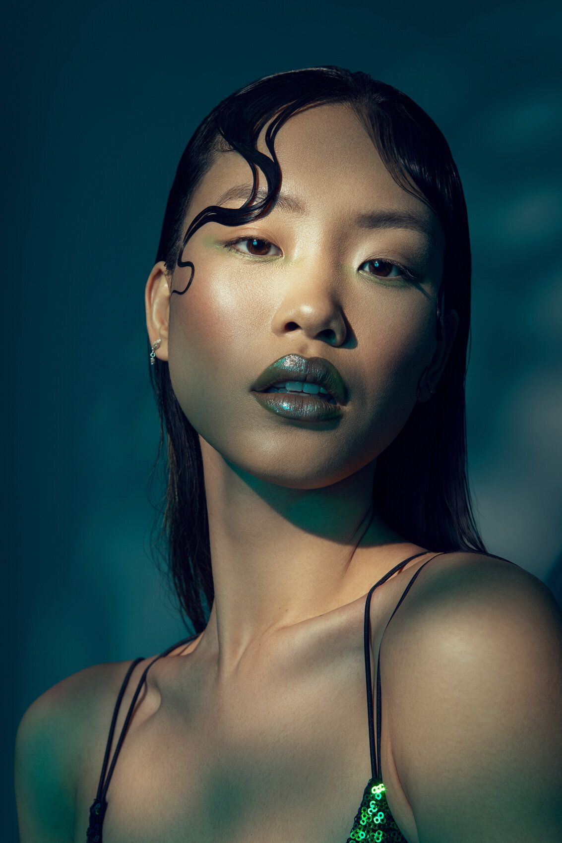 Bold portrait of Jiaqi with dark lipstick and an intense expression, captured by Ylva Erevall under soft lighting.
