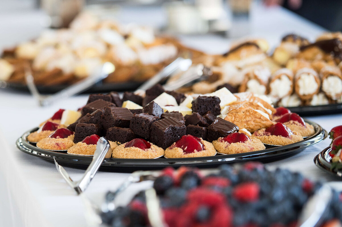 a closeup photo of brownies and drop cookies being served as part of a corporate anniversary celebration.  Captured by Ottawa Event Photographer JEMMAN Photography COMMERCIAL