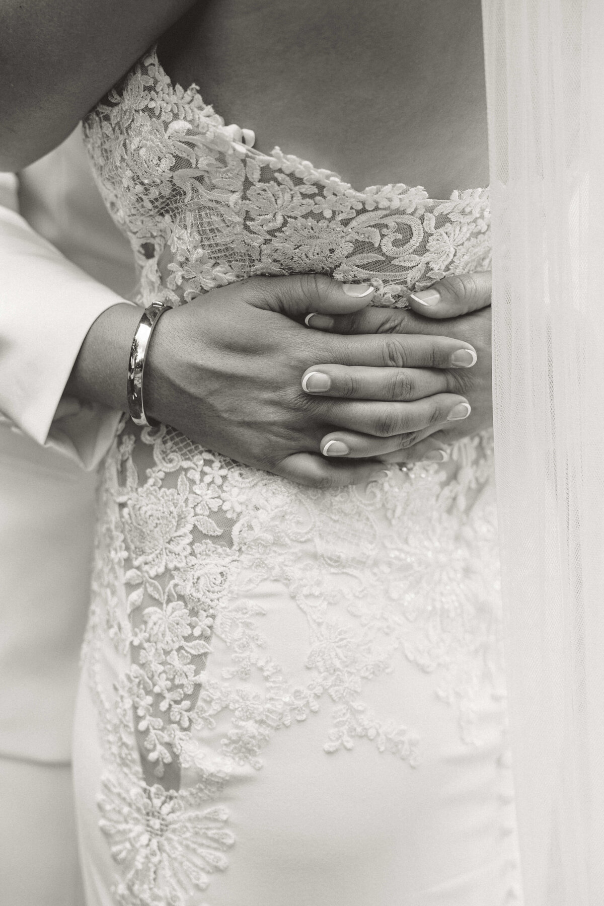 Close Up of Hands on Lace Wedding Dress