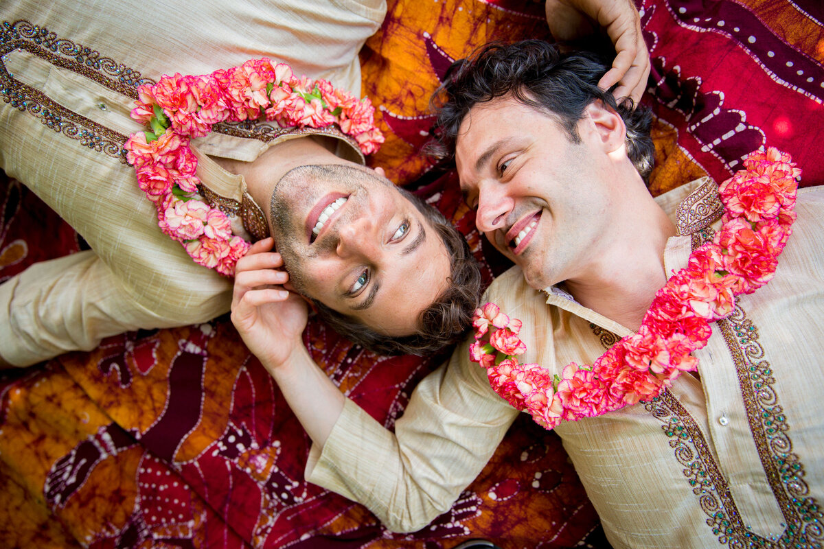 Two grooms lying on the floor together.