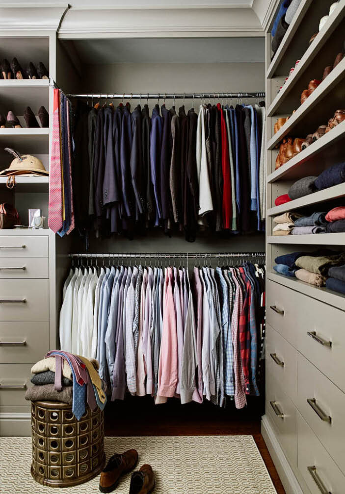 Custom-painted grey cabinets in the primary closet, featuring double hanging spaces, shoe shelves, and drawers. Designed to fit every wardrobe need. By Sarah Scales.