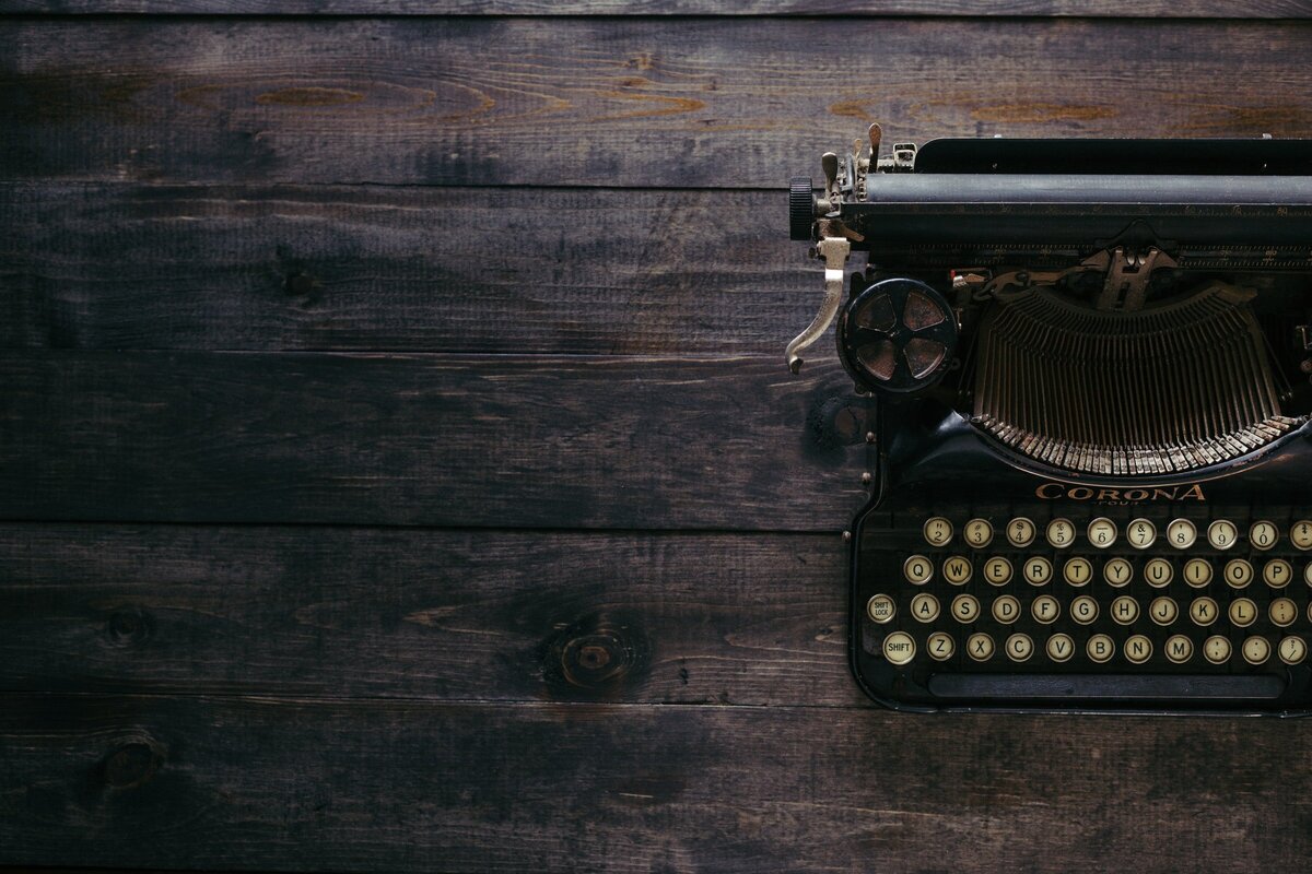 clean desk with dark wood with corona typewriter upon it