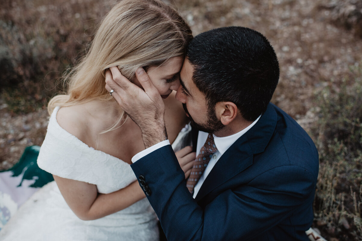 Photographers Jackson Hole capture groom touching bride's face