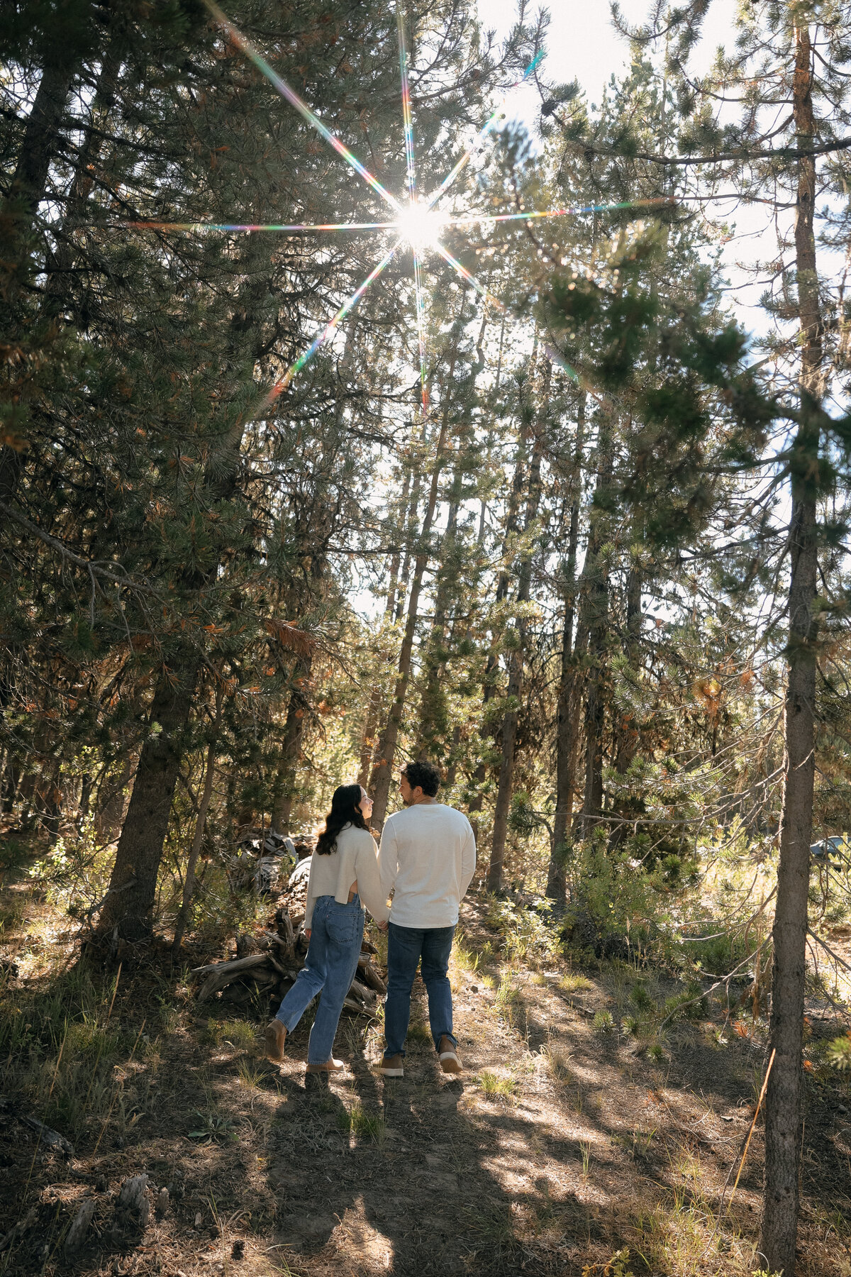 Playful Oregon Engagement Session with Couple Twirling in Meadow