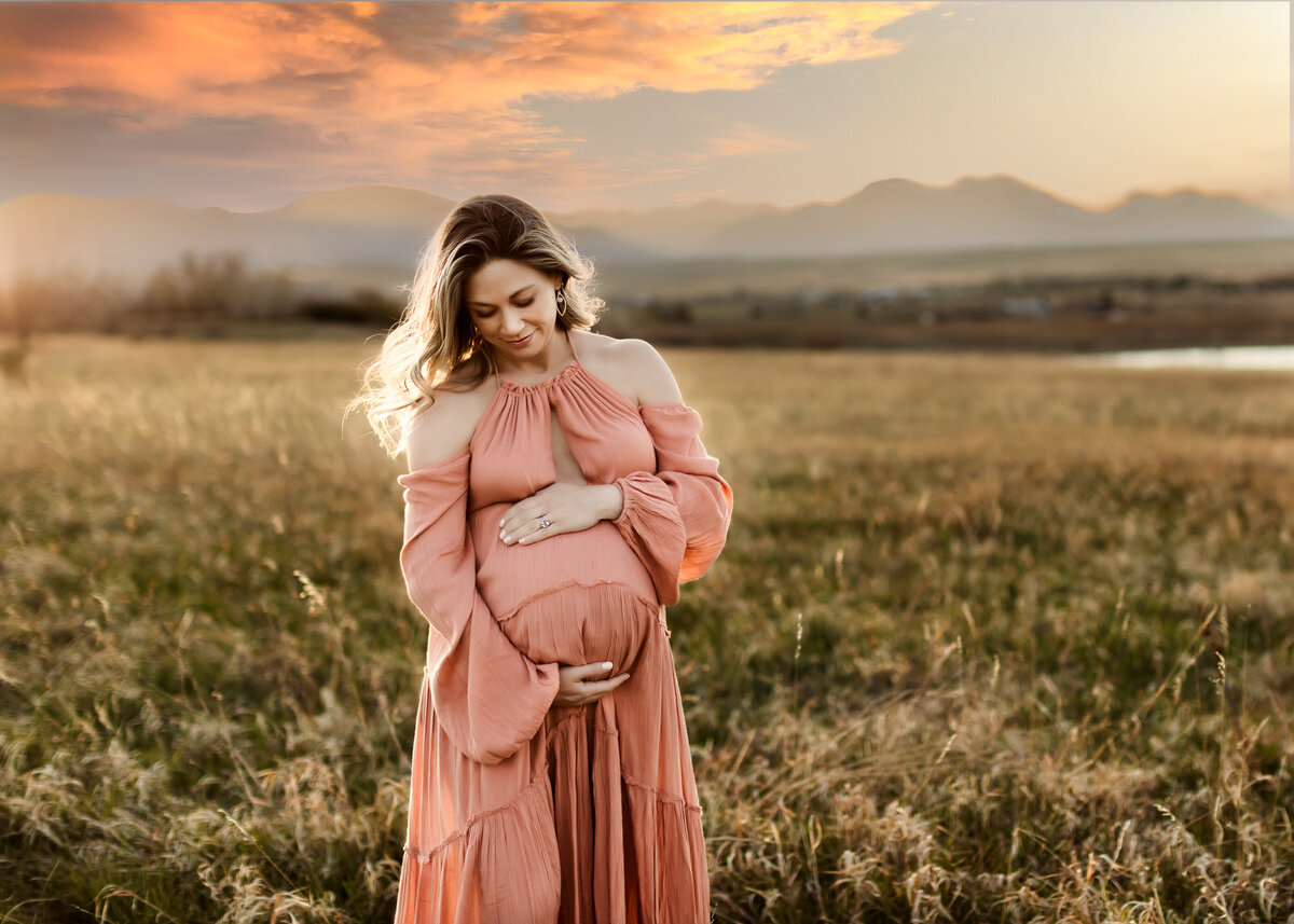 golden hour pregnancy photography in Denver Colorado in a field in the summer sun