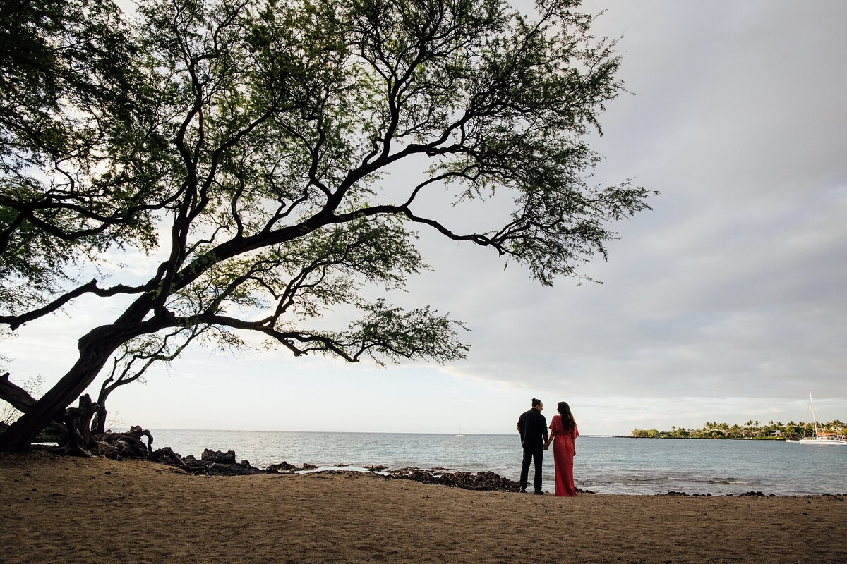 couple standing under a tree