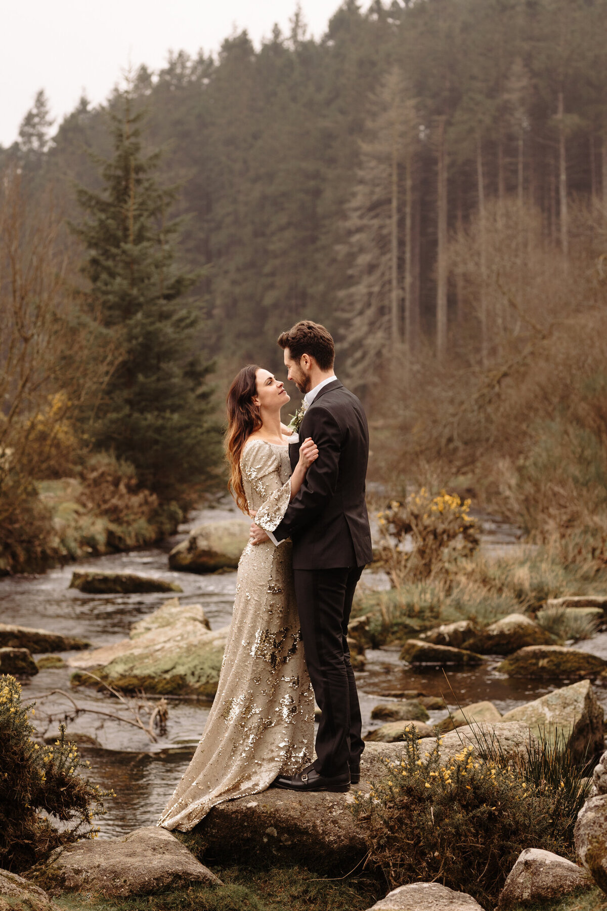 Couple stood on a rock at Bellever Forest