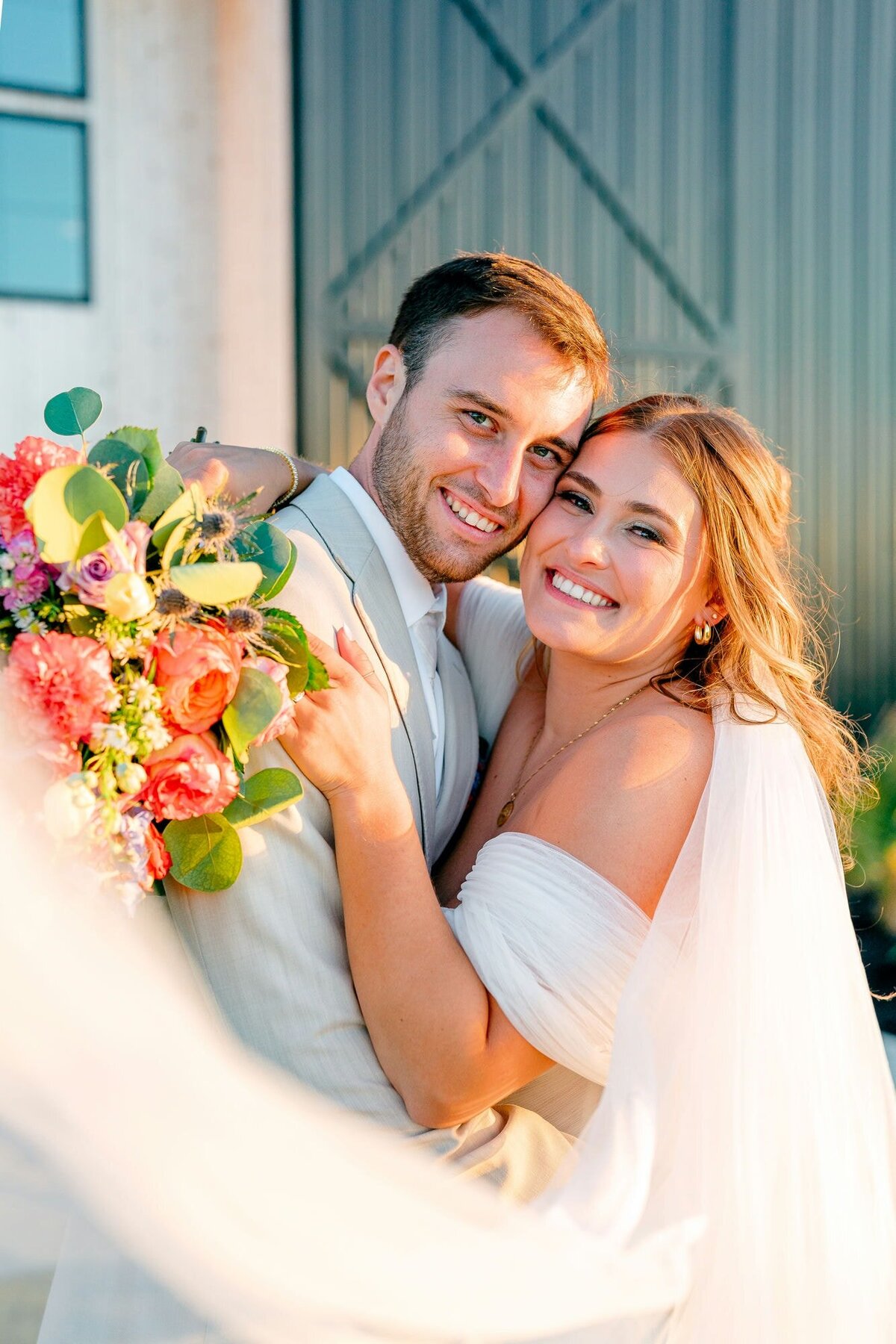 Bride_Groom_Embrace_With_Bouquet
