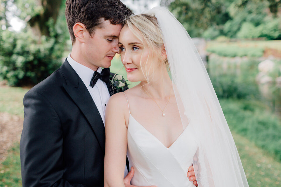 bride-and-groom-standing-close-at-castlemartyr-resort