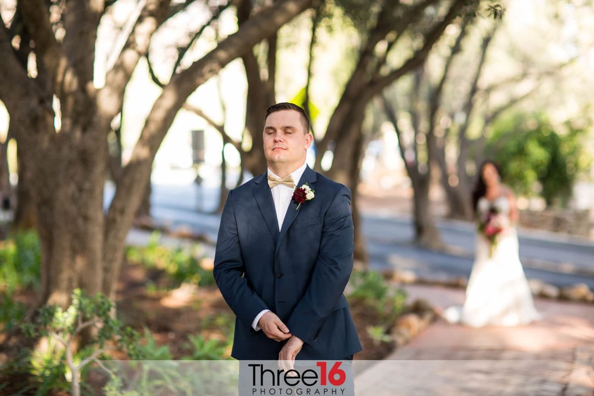 Groom waiting as Bride approaches for the First Look