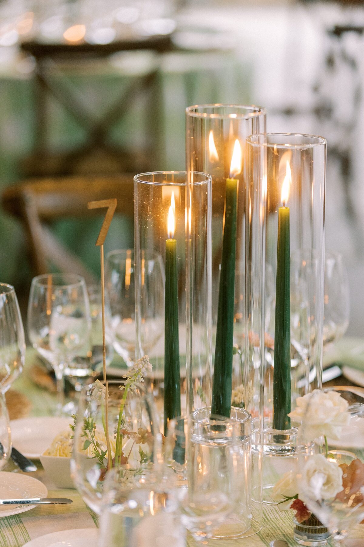 Wedding reception table with green pillar candles