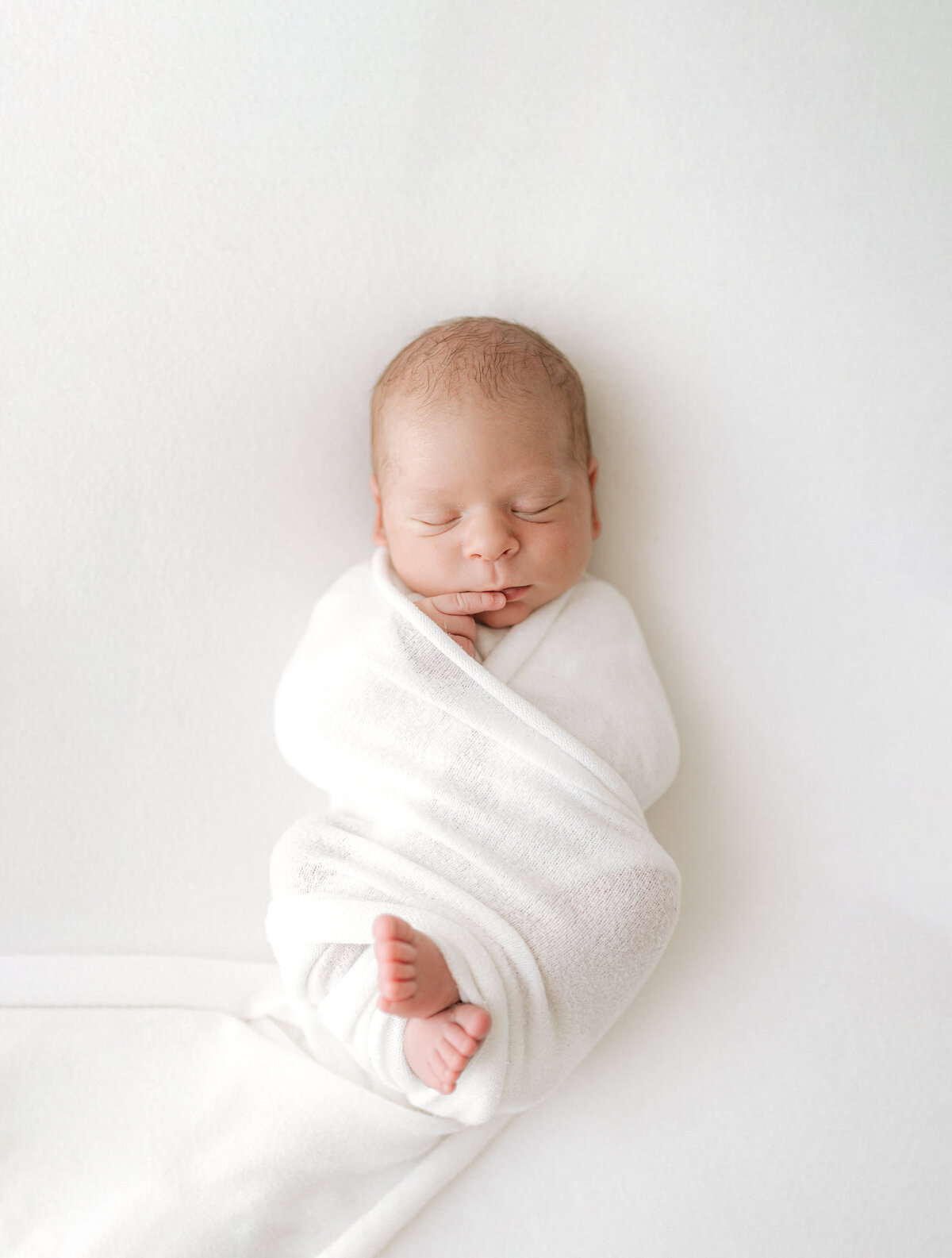 Baby swaddled during newborn photoshoot