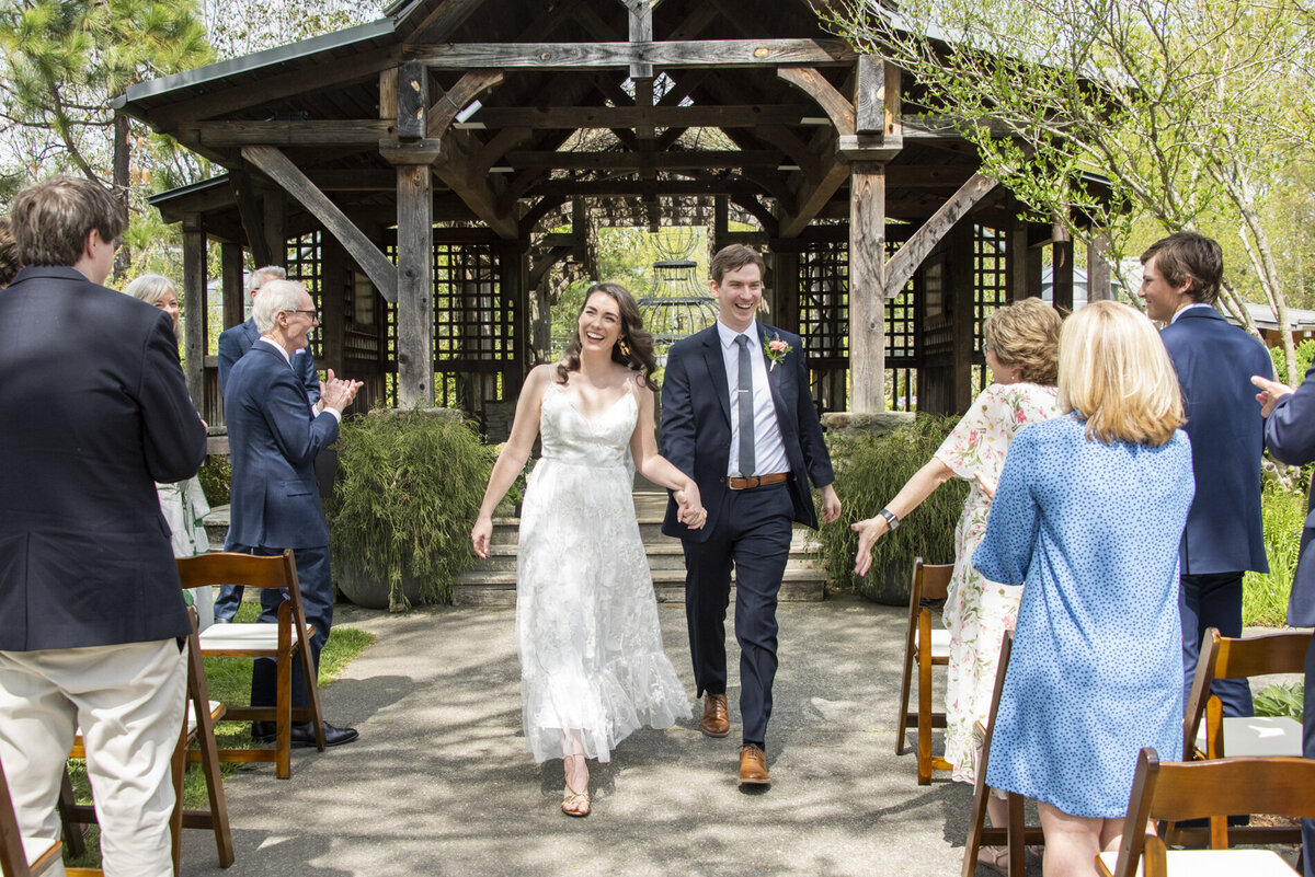 Couple walking down aisle at NC Arboretum wedding