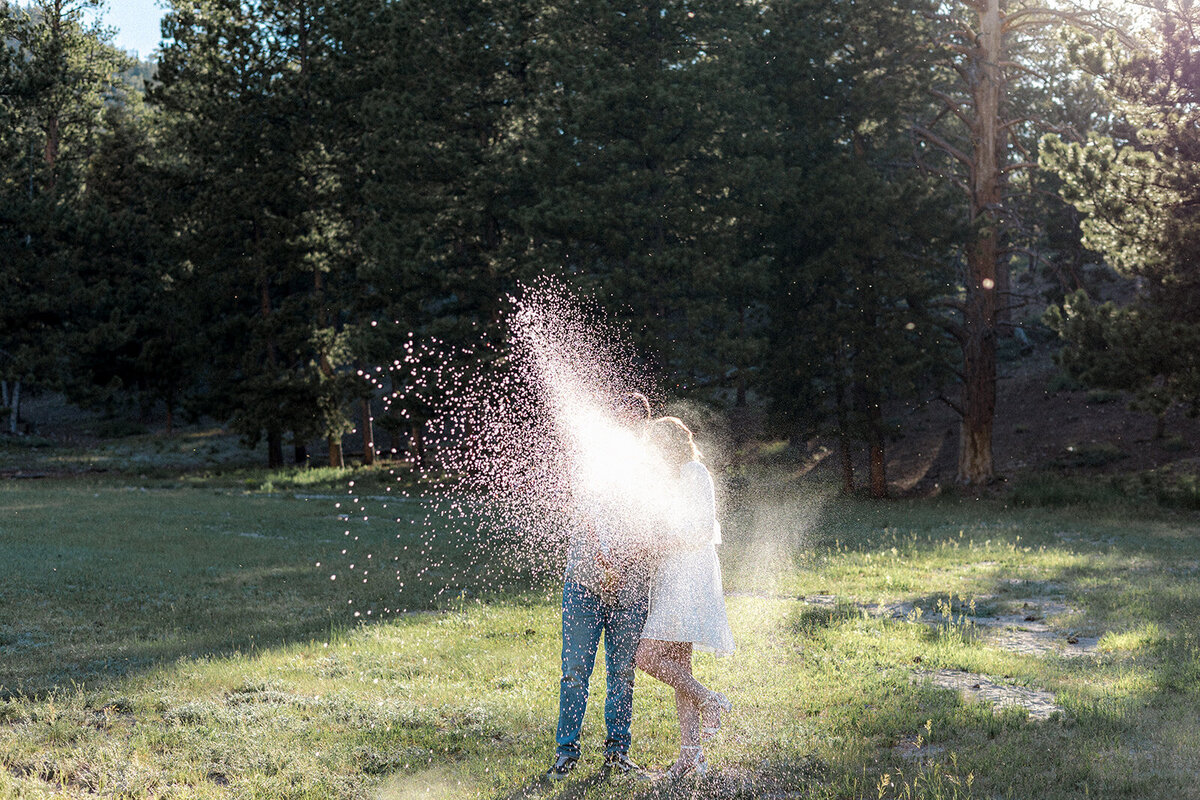 The couple is engulfed in a shimmering spray of champagne