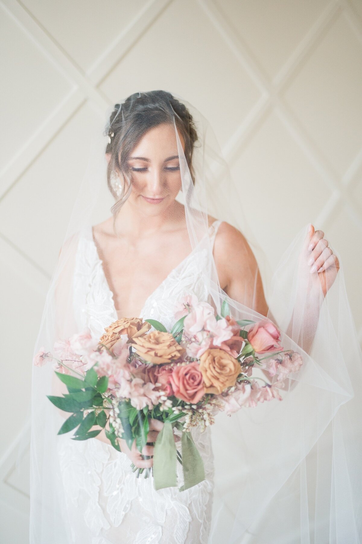 Bridal portrait of bride underneath long veil at a Greensboro wedding venue