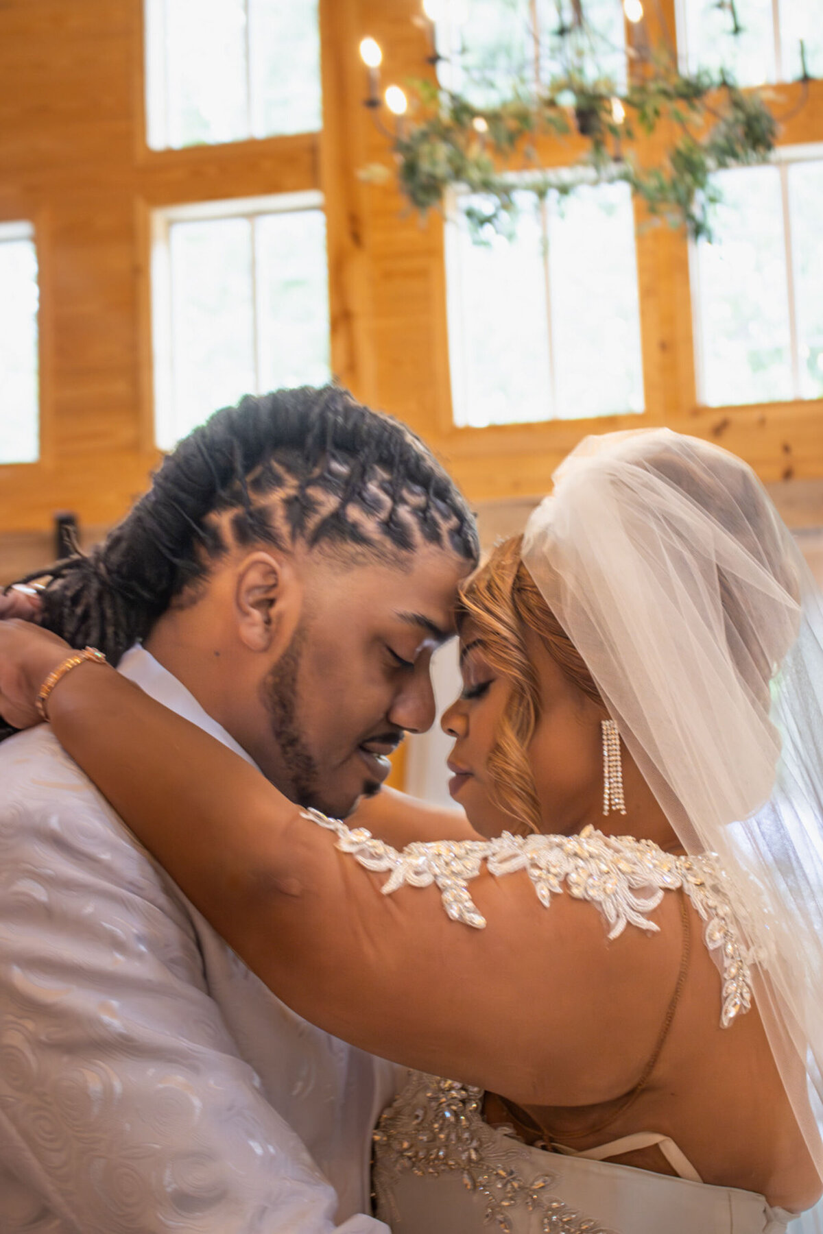 Bride and groom embracing forehead to forehead