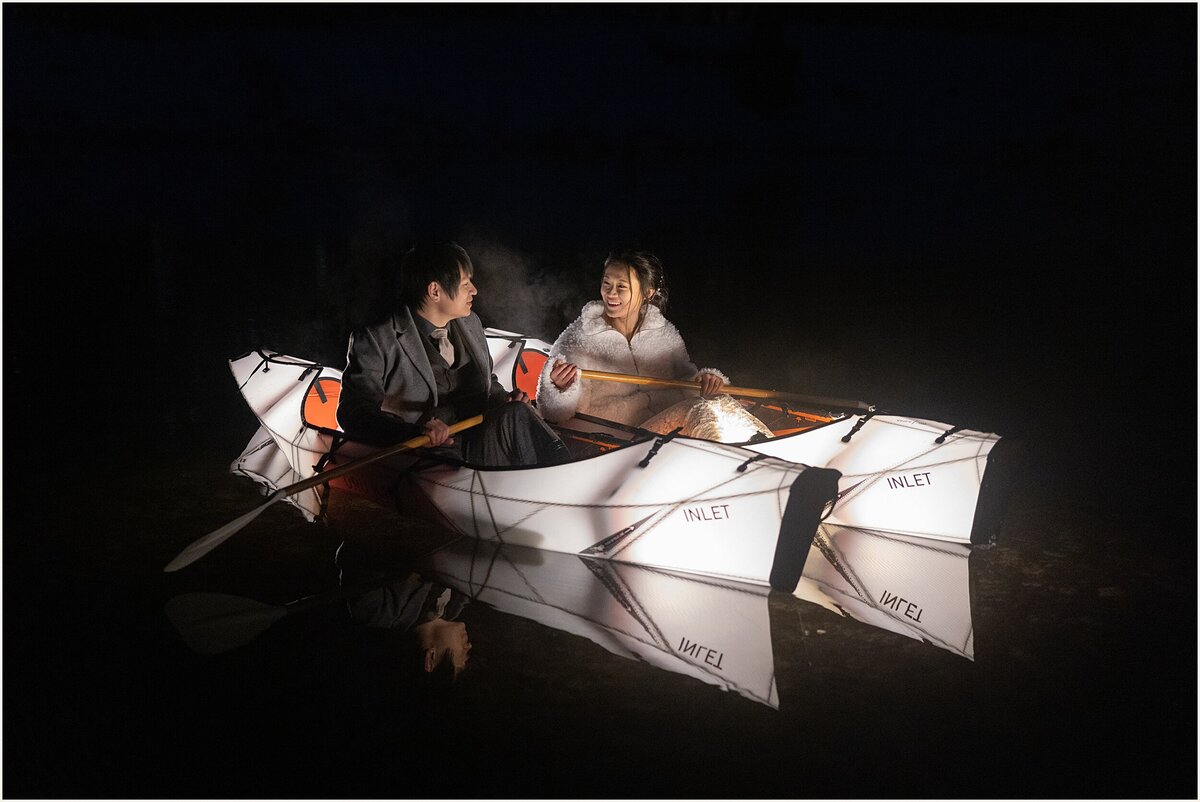 The bride and groom ride kayaks in Yosmemite