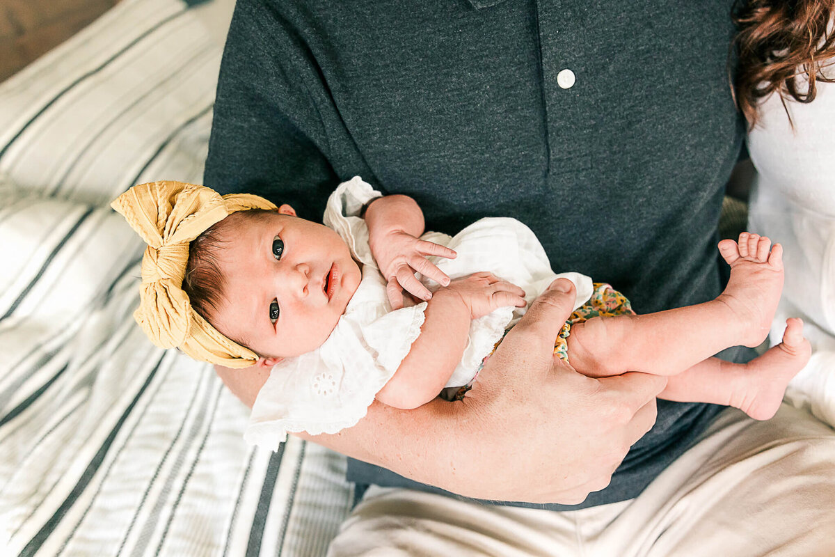 Baby looking at camera with feet in shot