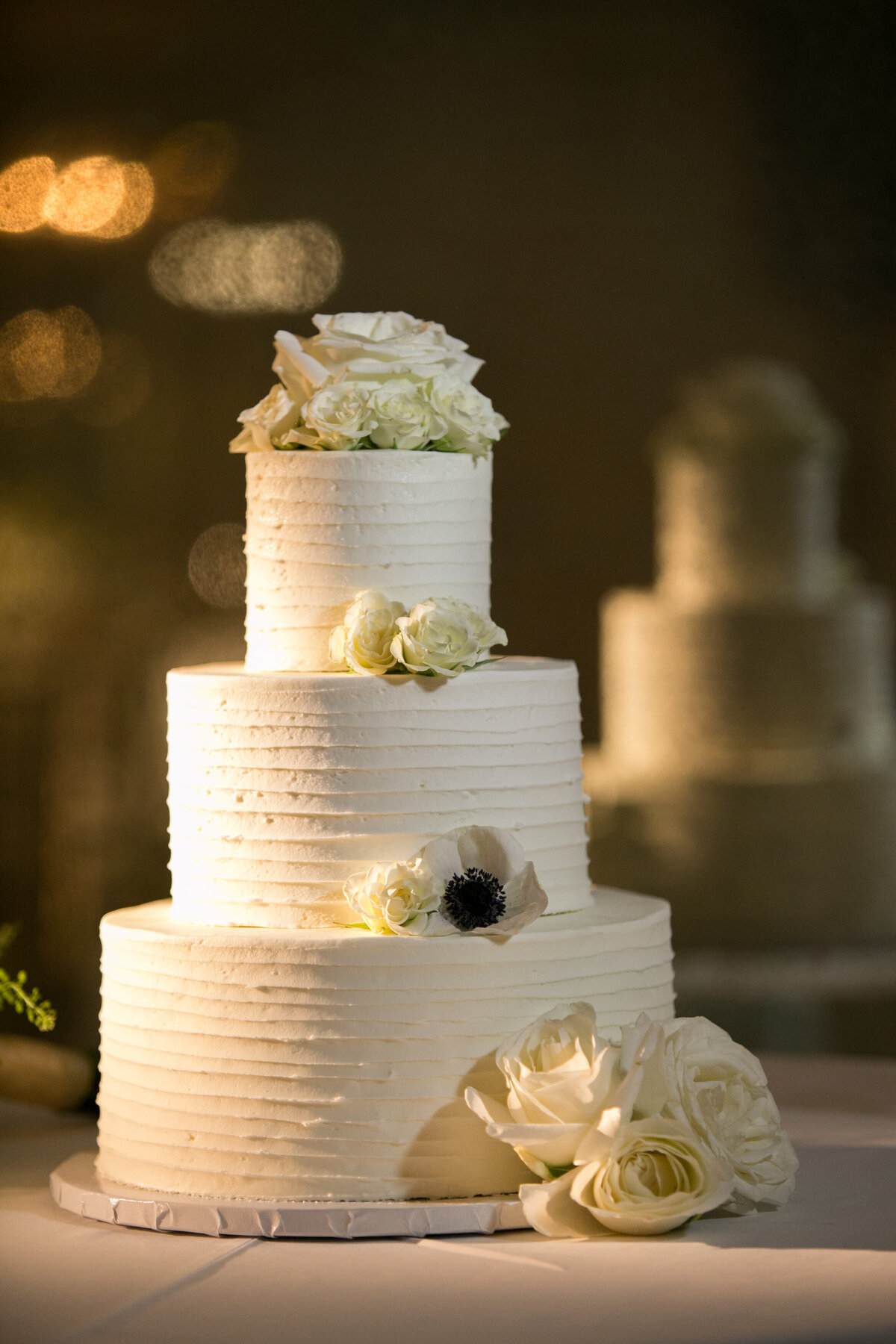 a three tiered wedding cakes with white flowers