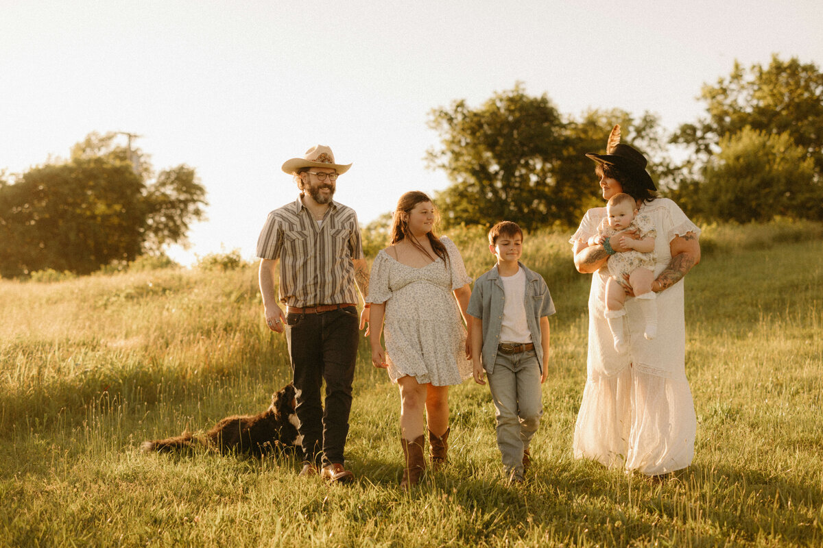 Family walking through field at sunset during Nashville Tennessee outdoor family photography session